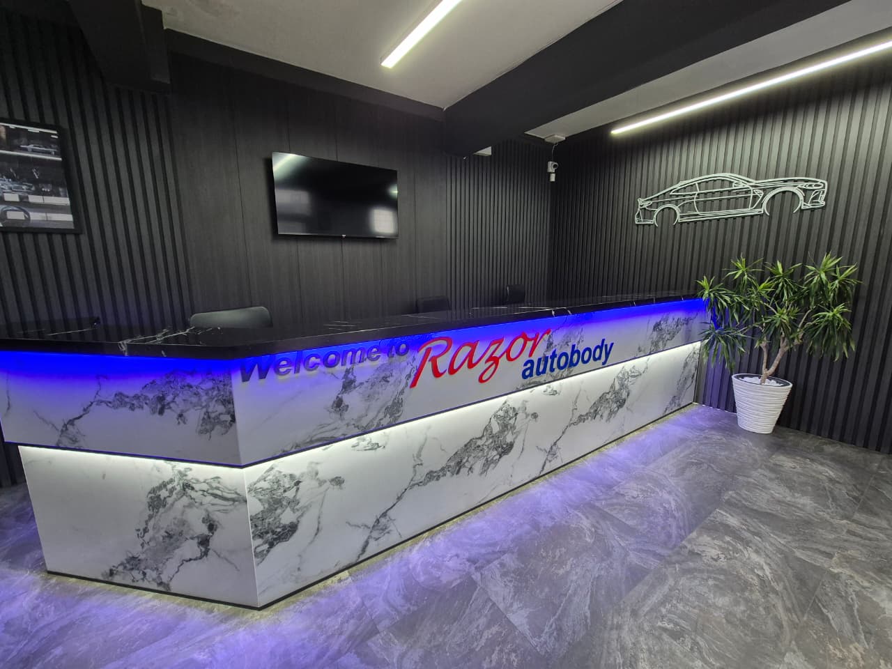 Welcome to Razor Autobody – modern reception desk with blue LED lighting